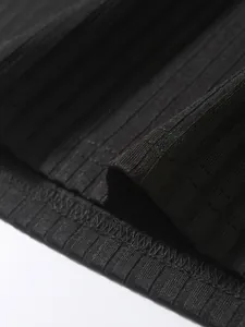 Macro detail of black ribbed fabric and high-quality stitching on a men's sports tank top