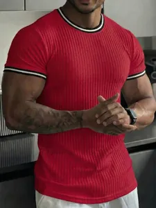 Detailed view of red ribbed fitness T-shirt showing muscular fit and striped collar trim