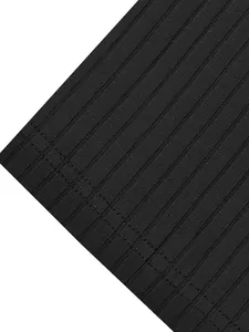 Macro detail of black ribbed fabric texture and stitching on a men's sports T-shirt.