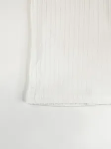 Macro view of white ribbed fabric texture and hem stitching on men's T-shirt