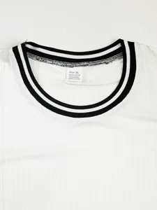 Detailed view of white ribbed crew neck T-shirt with black striped collar and fabric tag