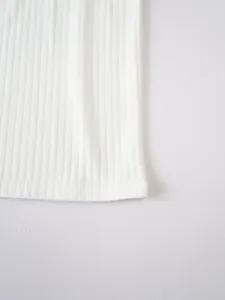 Detailed macro view of white ribbed knit fabric texture and bottom hem on men's athletic vest