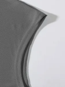 Macro view of breathable mesh fabric detail on grey athletic sleeveless tank top.