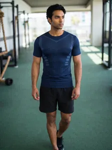Detailed view of dark blue breathable sports t-shirt worn by model in gym setting