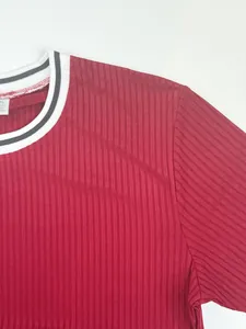 Detailed view of the ribbed texture and striped neckline on a red athletic t-shirt