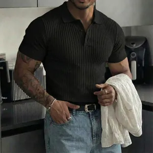 Detail of a men's slim fit ribbed polo shirt showing textured fabric and button collar.