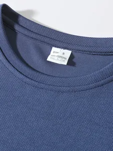 Close-up of navy blue breathable mesh fabric and size label on men's sports top