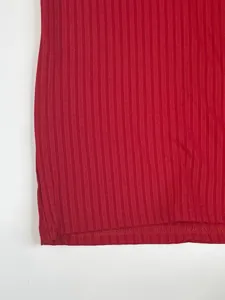 Close-up of red ribbed fabric texture and bottom hem stitching on a quick-dry T-shirt