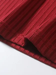 Detailed macro shot of red ribbed fabric texture and durable stitching on men's sports tank top