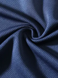 Close-up macro shot of breathable navy blue mesh fabric texture for men's sports tank top