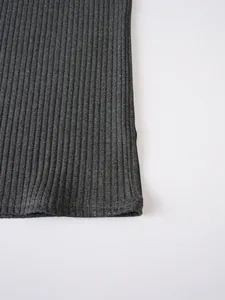 Macro view of grey ribbed knit fabric showing the detailed vertical texture and hemline