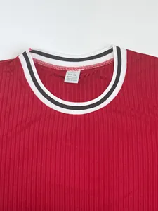 Detailed macro shot of red ribbed T-shirt neckline featuring size XL and fabric content tag
