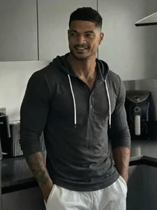 Dark grey henley hoodie for men with white drawstrings and button detail.