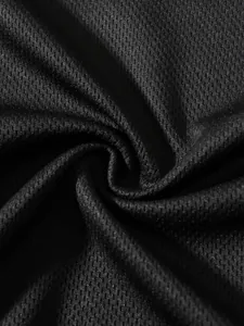 Macro view of breathable black mesh fabric texture for high-performance sports apparel