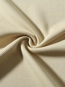 Macro detail of breathable beige mesh fabric for summer sportswear t-shirts and vests