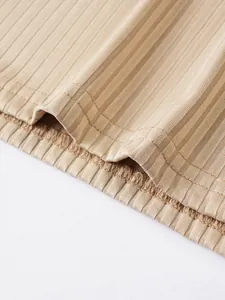 Close-up of beige ribbed fabric texture and fine hem stitching on men's slim fit tank top