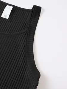 Close-up detail of black ribbed knit tank top showing fabric texture and care label