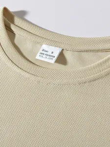 Close-up detail of mesh athletic top neckline showing Size S label and fabric texture.