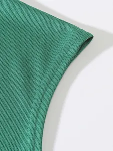 Macro view of high-quality green breathable mesh fabric texture on athletic sports tank top
