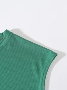 Close-up of green breathable mesh fabric on a sports sleeveless fitness tank top.