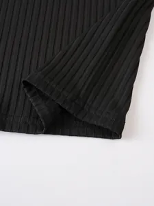 Close-up showing the fine ribbed knit texture and double-stitched hem of black men's tank top.