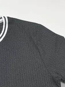 Close-up detail of a men's dark grey ribbed T-shirt with a striped crew neckline.