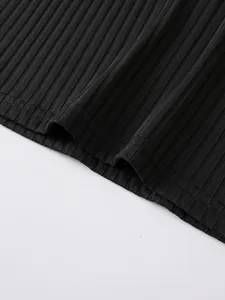 Detailed macro shot of the black ribbed fabric texture and hem of the men's athletic vest