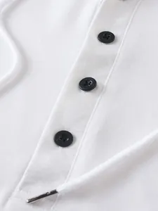 Close-up detail of white hooded sweatshirt featuring black buttons and thick drawstring cord.
