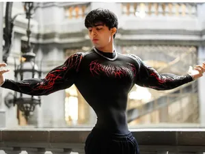 Close-up of Breathedivinity men's compression shirt with red graphic print on black fabric
