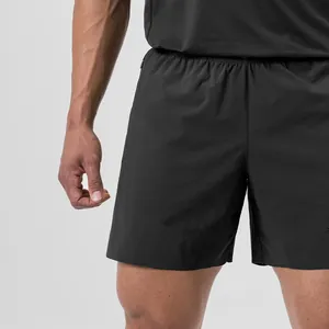Close-up detail of black men's quick-dry athletic shorts with laser-cut ventilation