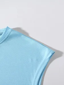 Detailed view of light blue breathable mesh fabric on a sports fitness tank top