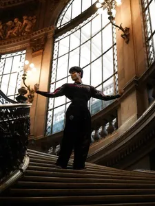 Muscle-fit men's fitness compression shirt featuring red tribal graphics on a grand staircase.