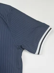 Close-up detail of navy ribbed fabric and striped cuff on a men's sports t-shirt.