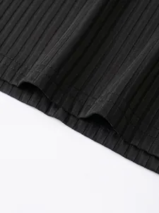 Close-up detail of black vertical ribbed fabric texture and hem stitching on polo vest