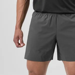 Close-up view of lightweight quick-dry woven sports shorts for men in charcoal gray