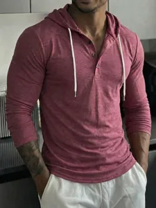 Detailed shot of a pinkish-red men's long-sleeve hooded Henley shirt with white drawstrings