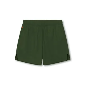 Detail view of men's dark green quick-dry athletic shorts with an elastic waistband