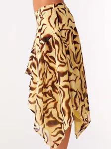 Close-up detail showing the asymmetrical draped hem and bold tiger print of the mini skirt