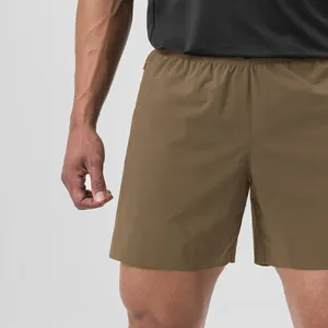 Close-up detail of men's brown quick-dry athletic shorts for running and fitness training.