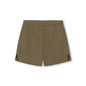 Macro view of olive men's quick-dry athletic shorts featuring laser-cut side slits