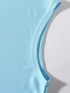 Close-up of breathable light blue mesh fabric and stitching on a men's sports tank top.
