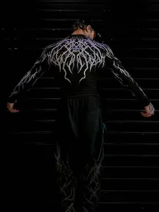 Detailed back view of men's black compression shirt with purple gothic graphic print.