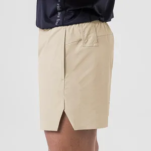 Detail view of men's quick-dry khaki sports shorts featuring side slit and pocket.