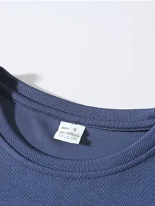 Detail of breathable mesh sports t-shirt neckline showing 100% polyester label