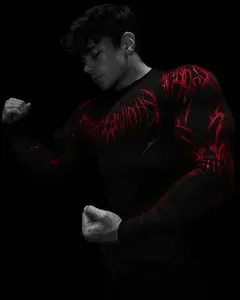 Close-up detail of a men's black compression gym shirt featuring a bold red graphic print