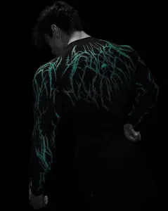 Rear view of black compression shirt with cyan lightning pattern and skull detail