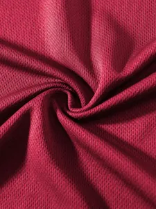 Close-up detail view of red breathable mesh fabric for summer sports fitness tank tops