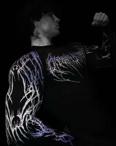 Close-up detail of the purple lightning print on a men's black quick-dry fitness compression shirt