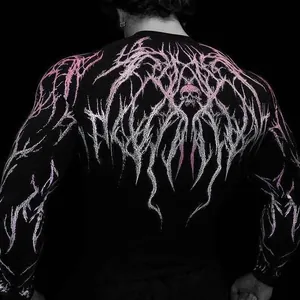Close-up detail of the pink and white skull graphic on a black compression gym shirt for men