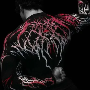 Detail view of the intricate red and white skull graphic on a black athletic compression shirt